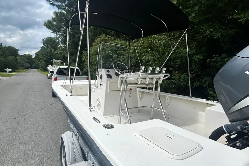 Slide: The Image of 2010 Southern Skimmer 19SS boat with canopy, parked on a residential street. - 6