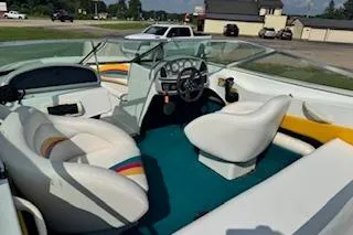 Slide: The Image of 1996 Baja 188 Islander boat interior with white seats and steering wheel. - 2