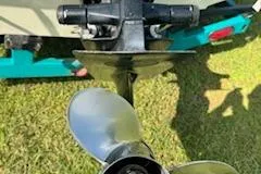 Slide: The Image of 1996 Baja 188 Islander boat engine and propeller on grass. - 5