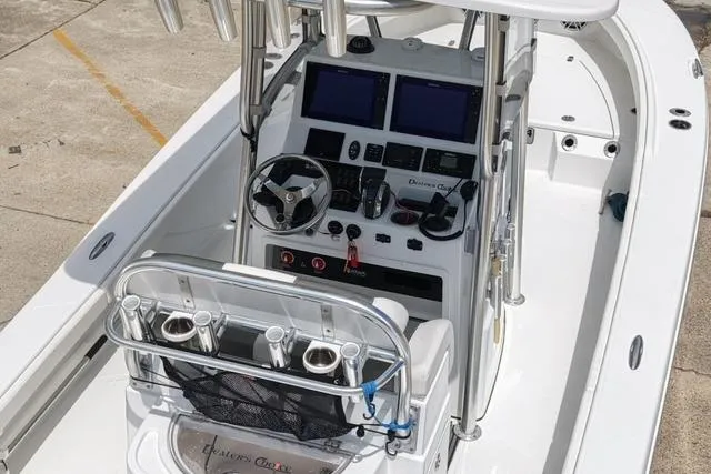 Slide: The Image of 2021 BlackJack 256 Bay boat interior with steering console and navigation screens. - 2