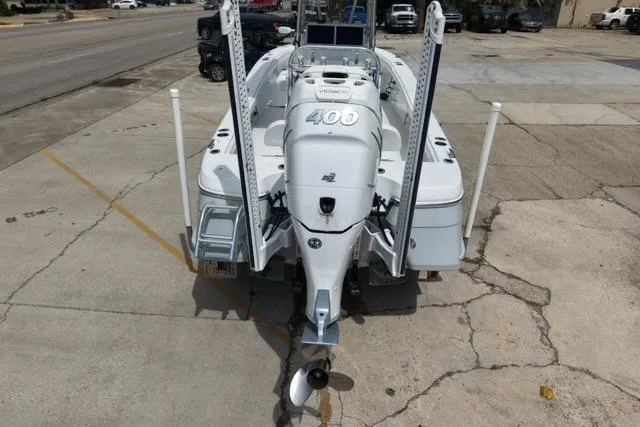 Slide: The Image of 2021 BlackJack 256 Bay boat with powerful outboard motor, parked on concrete surface. - 6