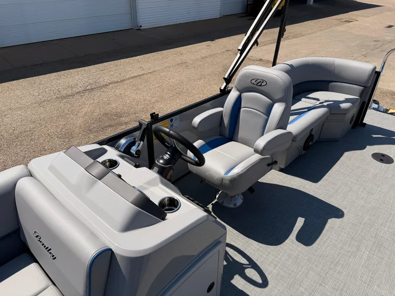 Slide: The Image of 2025 Bentley Pontoons Bolt 223 interior with plush seating and modern steering console. - 18