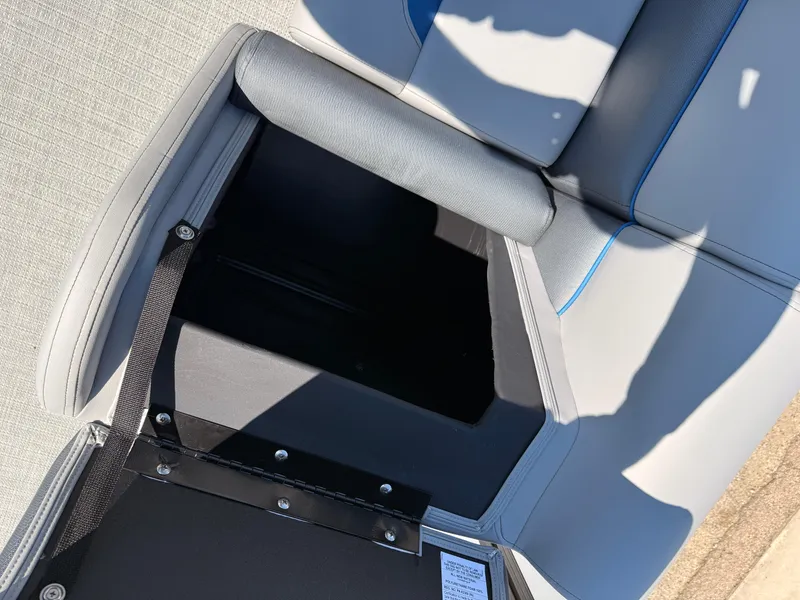 Slide: The Image of 2025 Bentley Pontoons Bolt 223 seat storage compartment, open with visible upholstery and shadow. - 22
