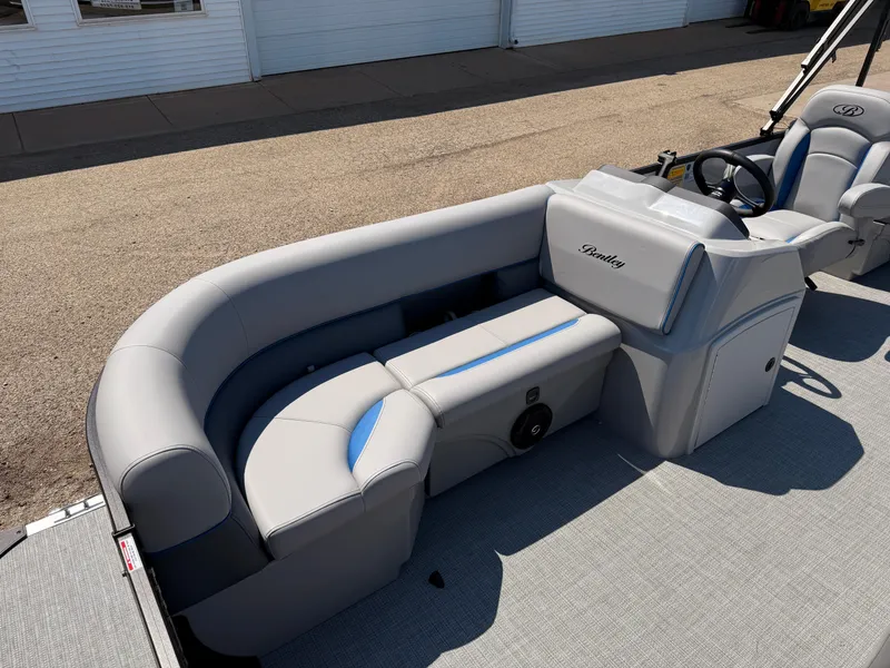 Slide: The Image of 2025 Bentley Pontoons Bolt 223 interior with gray seating and steering console. - 9