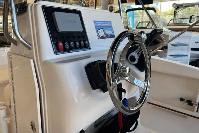 Slide: The Image of 2023 Grady White Fisherman 180 boat console with steering wheel and controls. - 5