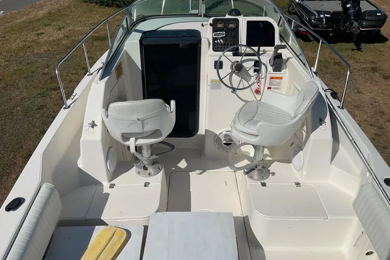 Slide: The Image of 1999 Hydra-Sports 230 SEA HOURSE WA boat interior with steering wheel and seating. - 10