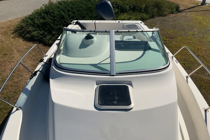 Slide: The Image of 1999 Hydra-Sports 230 SEA HOURSE WA boat, white exterior, parked on grass. - 11