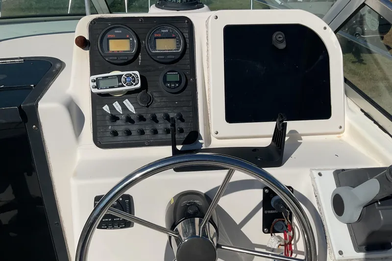 Slide: The Image of 1999 Hydra-Sports 230 SEA HORSE WA boat dashboard with steering wheel and gauges. - 12