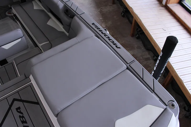 Slide: The Image of 2023 Moomba Makai boat interior with gray seating and sleek design. - 10