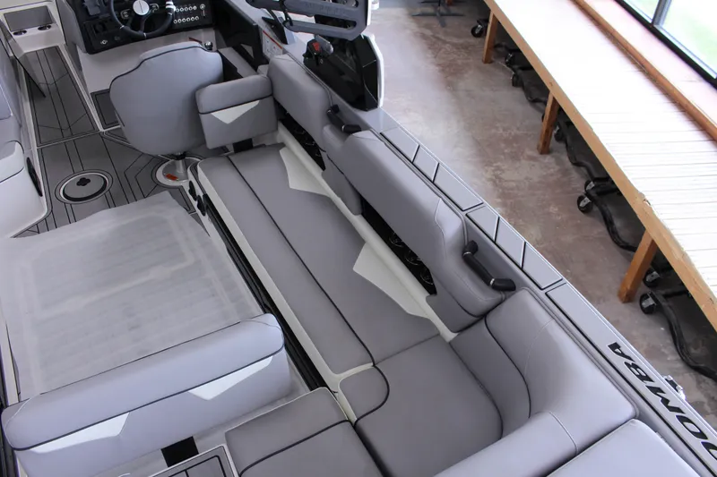 Slide: The Image of 2023 Moomba Makai boat interior with gray seating and modern dashboard design. - 11