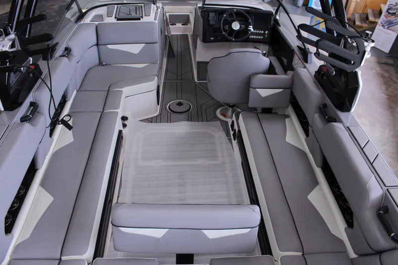 Slide: The Image of 2023 Moomba Makai boat interior with gray seating and modern dashboard design. - 12