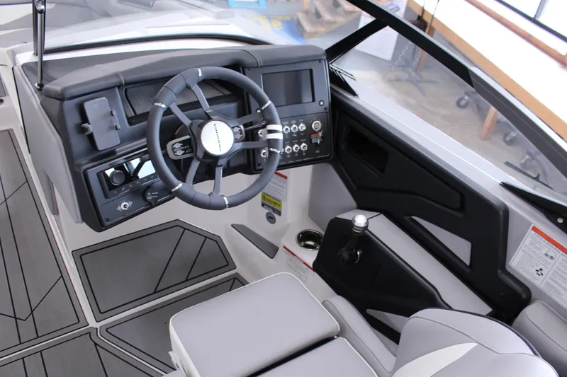 Slide: The Image of 2023 Moomba Makai boat cockpit with modern steering wheel and control panel. - 14