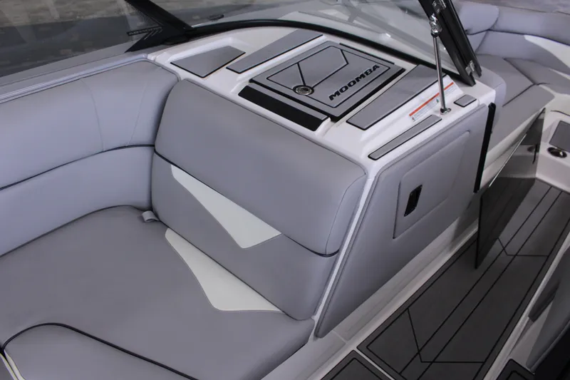 Slide: The Image of 2023 Moomba Makai boat interior with sleek gray seating and modern dashboard design. - 15