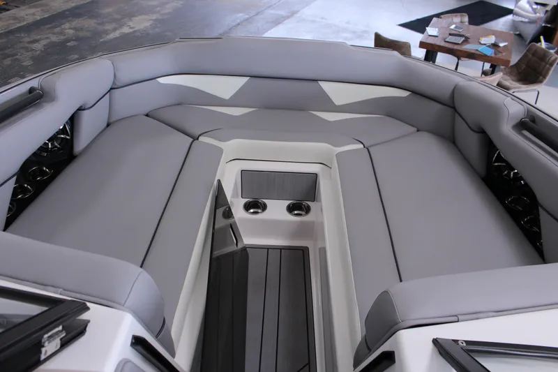 Slide: The Image of 2023 Moomba Makai boat interior with spacious gray seating and cup holders. - 16