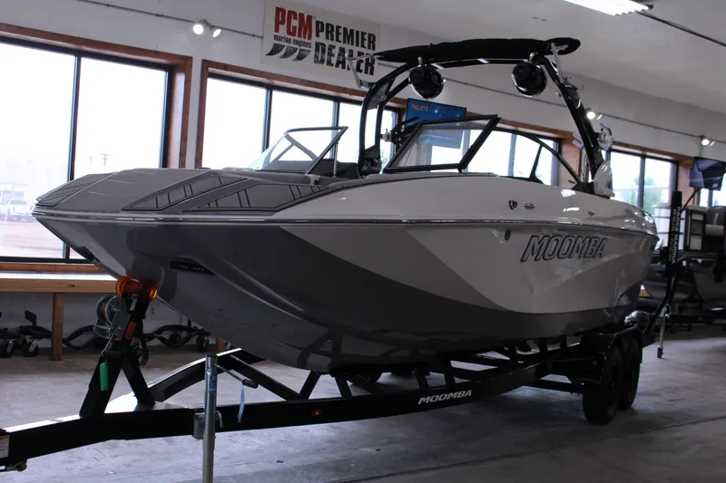 Slide: The Image of 2023 Moomba Makai boat on trailer in showroom, featuring sleek design and modern features. - 2