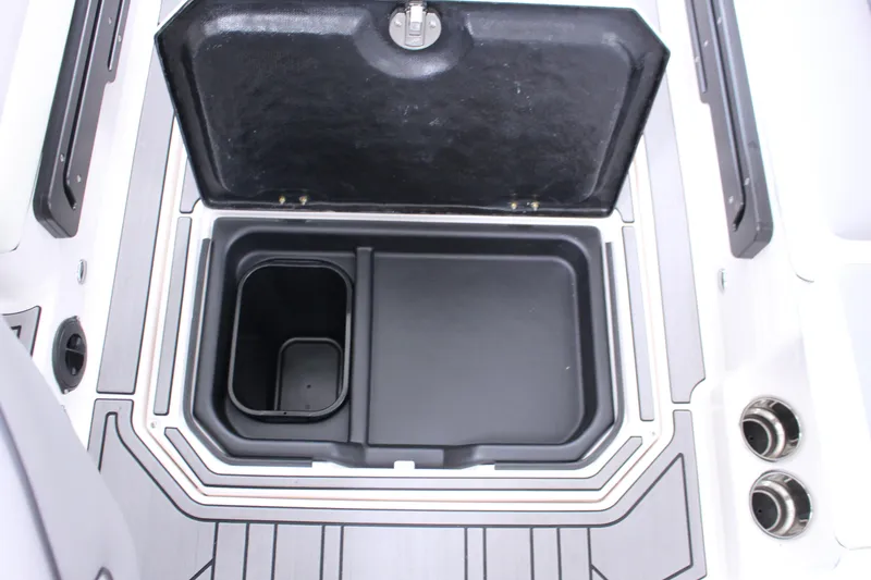 Slide: The Image of 2023 Moomba Makai boat storage compartment with open lid, showcasing interior design. - 24