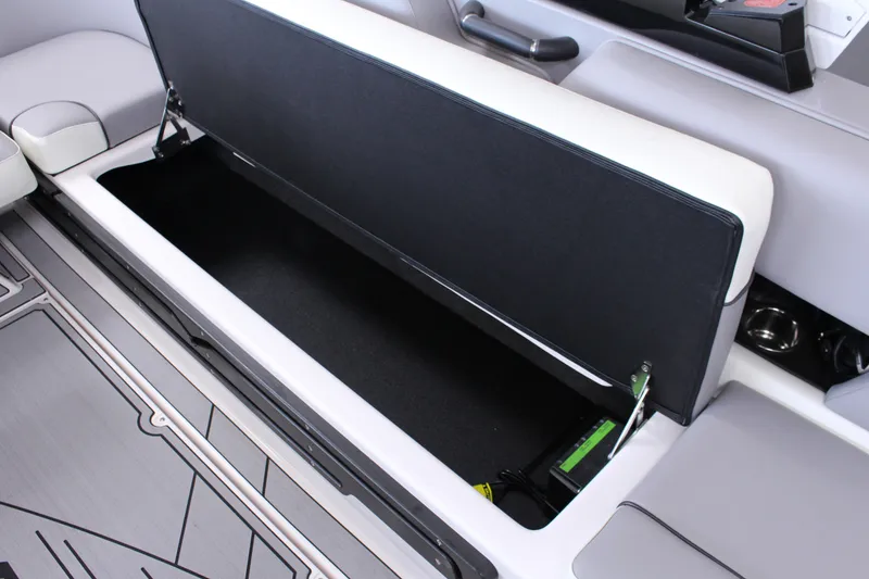 Slide: The Image of 2023 Moomba Makai boat interior storage compartment with open seat and sleek design. - 25