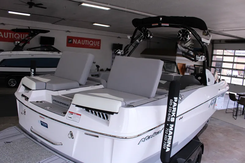 Slide: The Image of 2023 Moomba Makai boat in showroom, featuring sleek design and comfortable seating. - 28