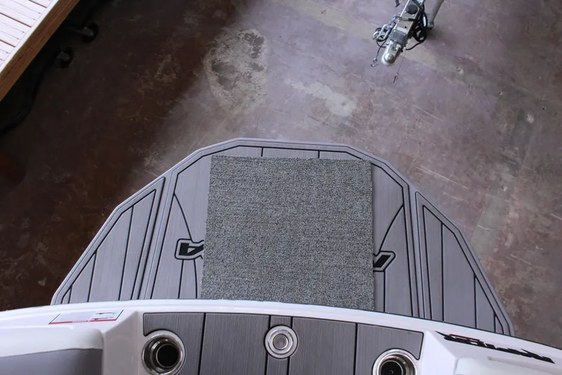 Slide: The Image of 2023 Moomba Makai boat swim platform with gray non-slip mat and cup holders. - 9