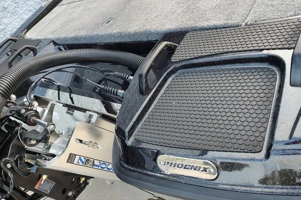 Slide: The Image of 2026 Phoenix 920 Elite X boat deck with textured grip and visible engine components. - 13