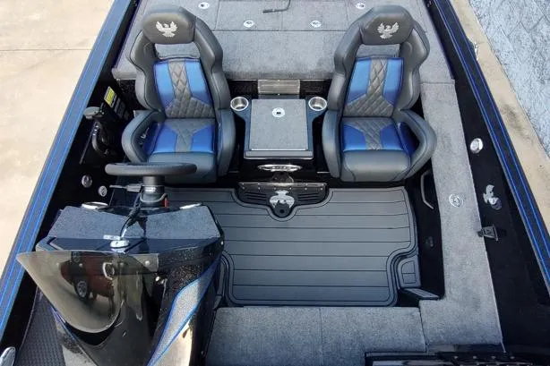 Slide: The Image of 2026 Phoenix 920 Elite X boat interior with dual blue and black seats, steering console, and carpeted flooring. - 5