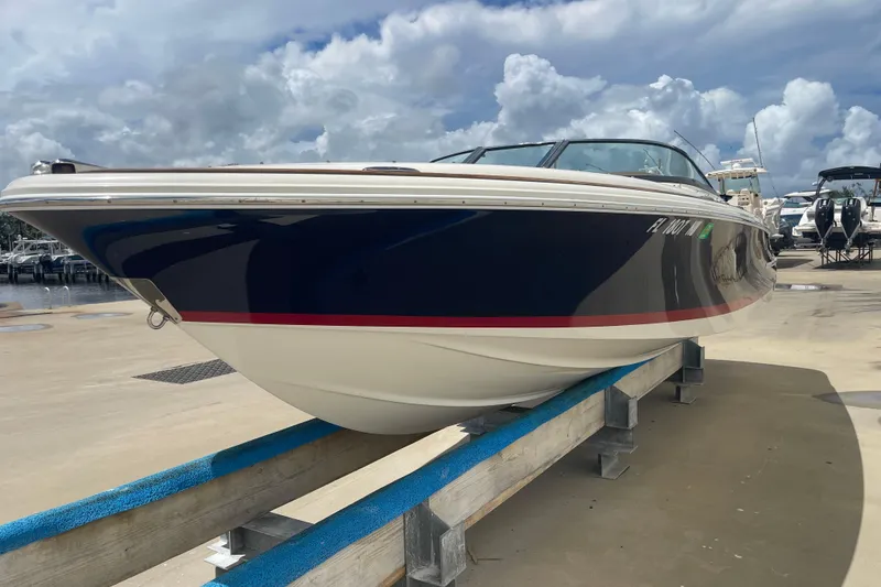 The Image of 2008 Chris-Craft Launch 25 boat on a dock, under a cloudy sky. - 0