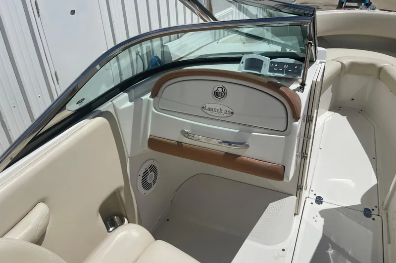Slide: The Image of 2008 Chris-Craft Launch 25 boat interior with beige seating and dashboard. - 14