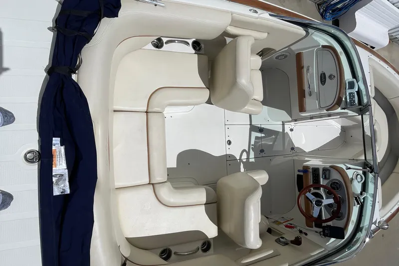 Slide: The Image of 2008 Chris-Craft Launch 25 boat interior with cream seats and wooden dashboard. - 15