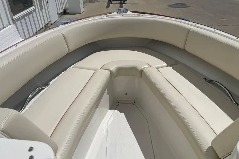 Slide: The Image of 2008 Chris-Craft Launch 25 boat interior with cream leather seating and stainless steel accents. - 18