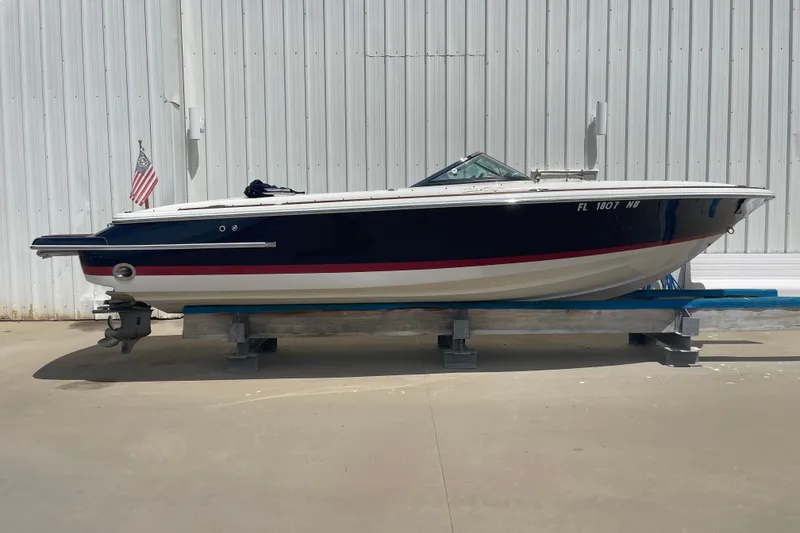Slide: The Image of 2008 Chris-Craft Launch 25 boat on display, side view, with American flag. - 2