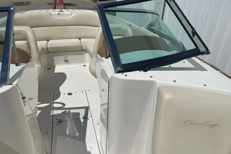 Slide: The Image of 2008 Chris-Craft Launch 25 boat interior with beige seating and windshield. - 22