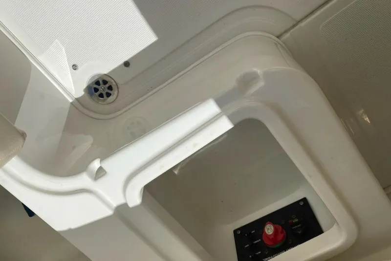 Slide: The Image of 2008 Chris-Craft Launch 25 boat interior with control panel and drainage area. - 25