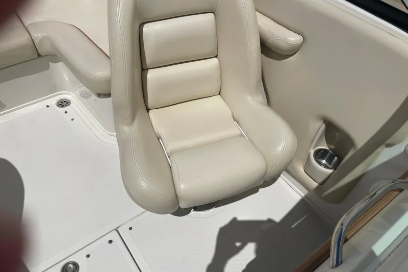 Slide: The Image of 2008 Chris-Craft Launch 25 boat interior with beige seating and cup holder. - 27