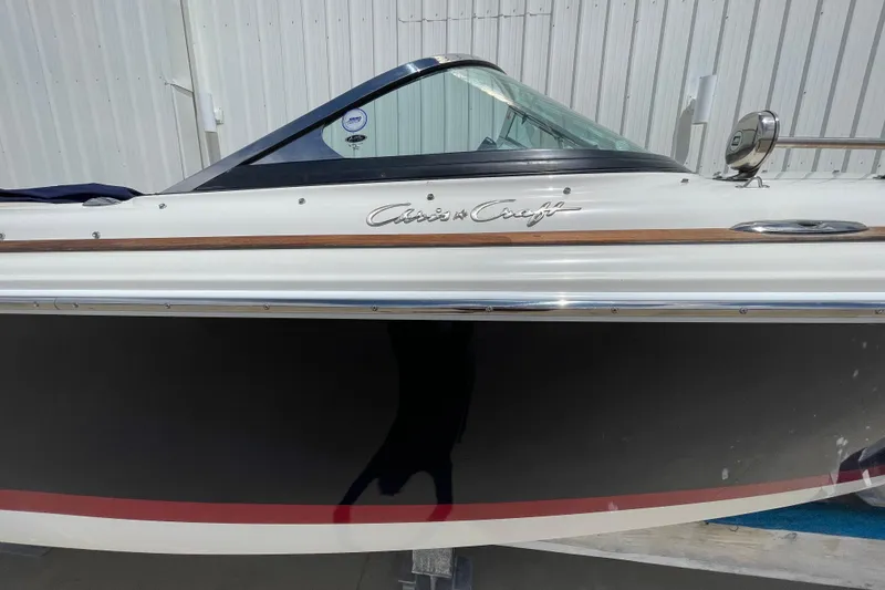 Slide: The Image of 2008 Chris-Craft Launch 25 boat, side view, showcasing sleek design and branding. - 3