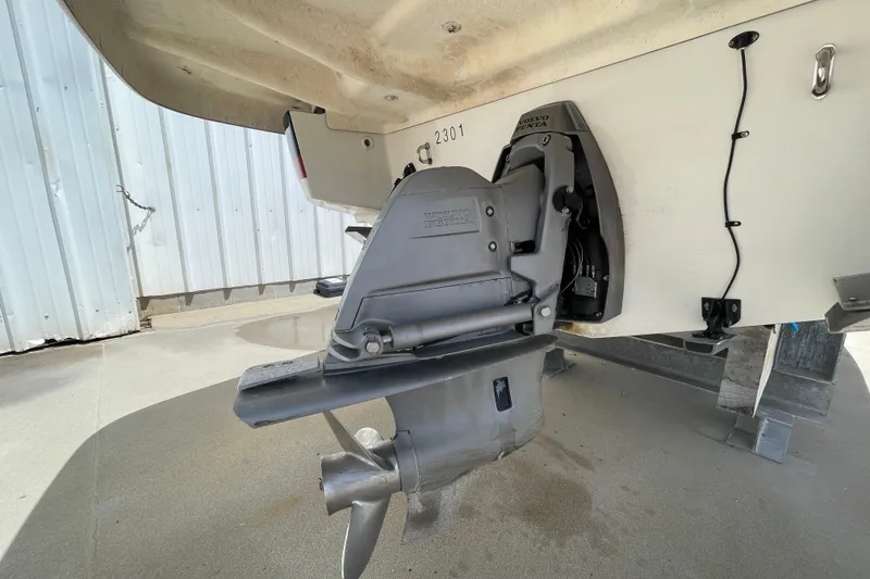 Slide: The Image of 2008 Chris-Craft Launch 25 boat with Volvo Penta outdrive, docked on concrete surface. - 34