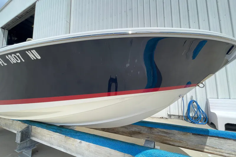 Slide: The Image of 2008 Chris-Craft Launch 25 boat docked, showcasing sleek hull design. - 4