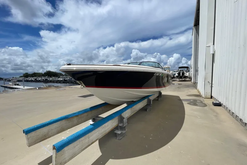 Slide: The Image of 2008 Chris-Craft Launch 25 boat on dock under cloudy sky, side view. - 7