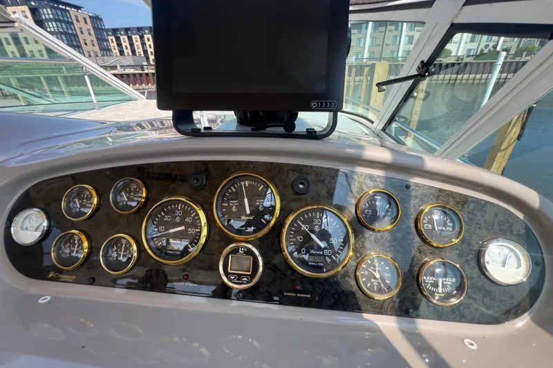 Slide: The Image of Dashboard of 2001 Cruisers Yachts 3672 Express with gauges and navigation screen. - 12
