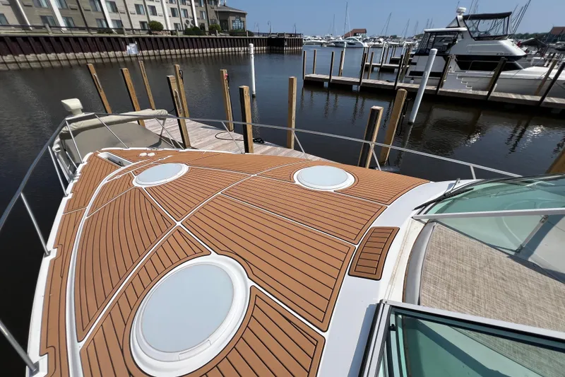 Slide: The Image of 2001 Cruisers Yachts 3672 Express docked at marina, featuring sleek deck design. - 15