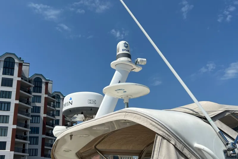 Slide: The Image of 2001 Cruisers Yachts 3672 Express with radar equipment against a clear blue sky. - 34