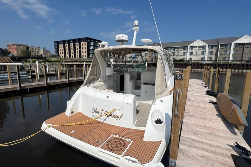 Slide: The Image of 2001 Cruisers Yachts 3672 Express docked at a marina with clear blue skies. - 4