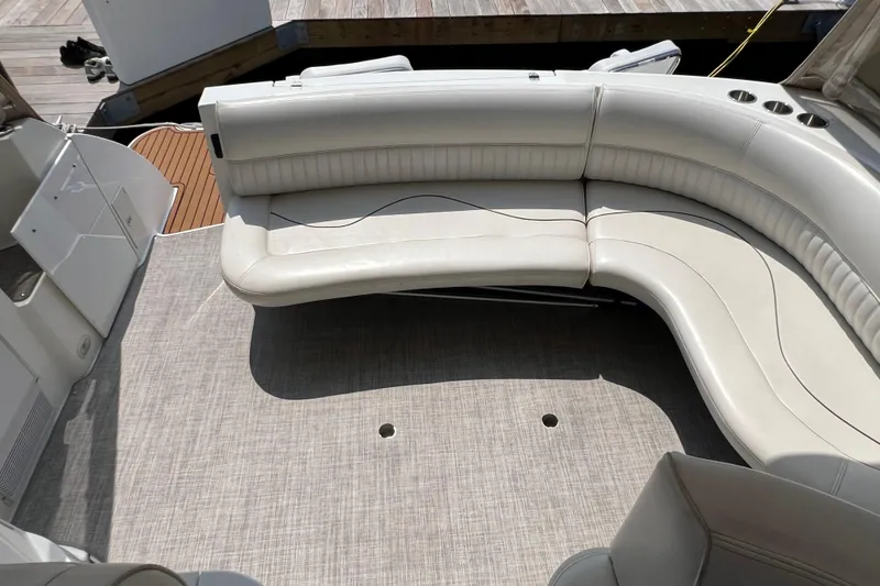 Slide: The Image of 2001 Cruisers Yachts 3672 Express interior with curved seating and carpeted floor. - 5