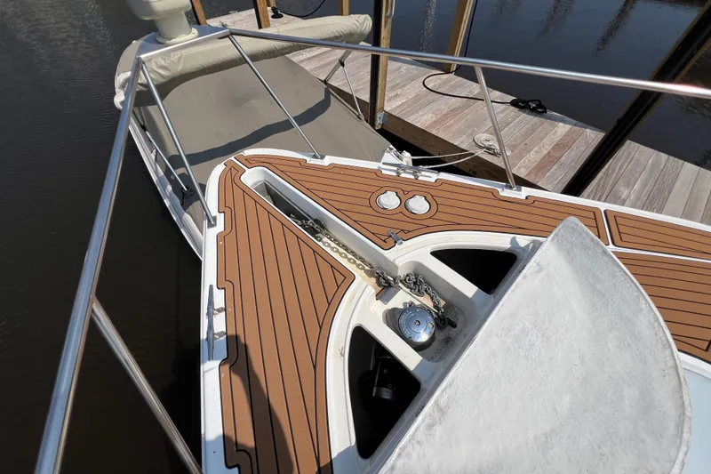 Slide: The Image of 2001 Cruisers Yachts 3672 Express boat deck with anchor and wooden finish. - 16