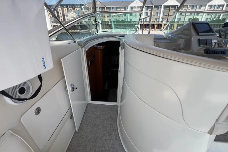 Slide: The Image of 2001 Cruisers Yachts 3672 Express interior view with open cabin door and control panel. - 17