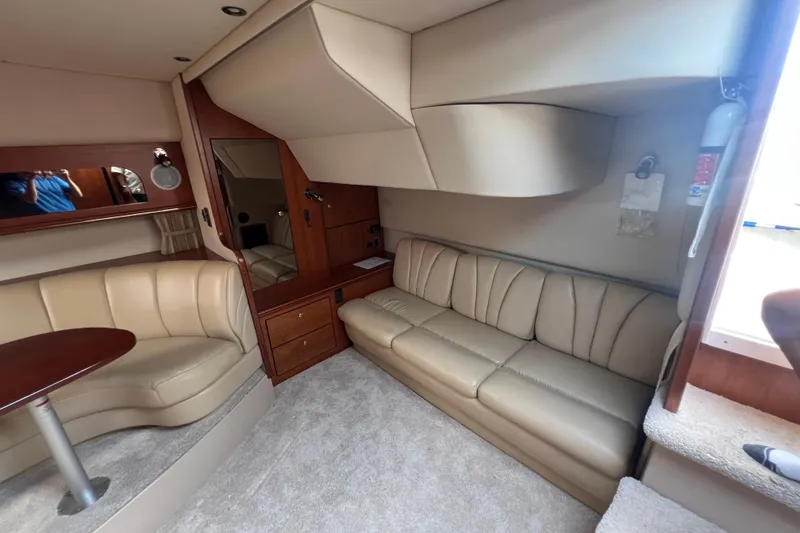 Slide: The Image of 2001 Cruisers Yachts 3672 Express interior with beige leather seating and wooden accents. - 20