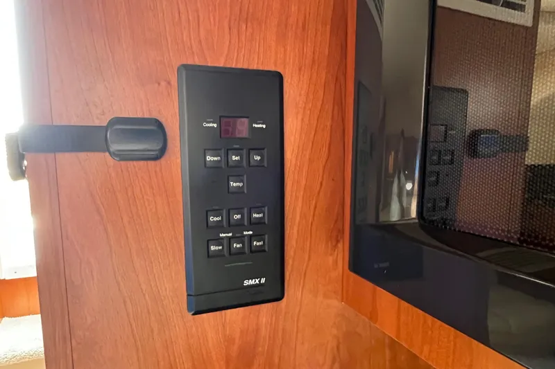 Slide: The Image of Control panel on 2001 Cruisers Yachts 3672 Express, featuring temperature and fan settings. - 23