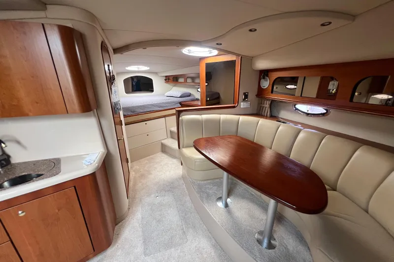 Slide: The Image of Luxurious interior of 2001 Cruisers Yachts 3672 Express with cozy seating and elegant wood finishes. - 24