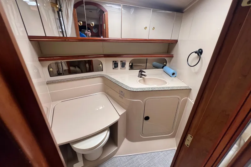Slide: The Image of 2001 Cruisers Yachts 3672 Express bathroom with sink, mirror, and storage cabinets. - 28