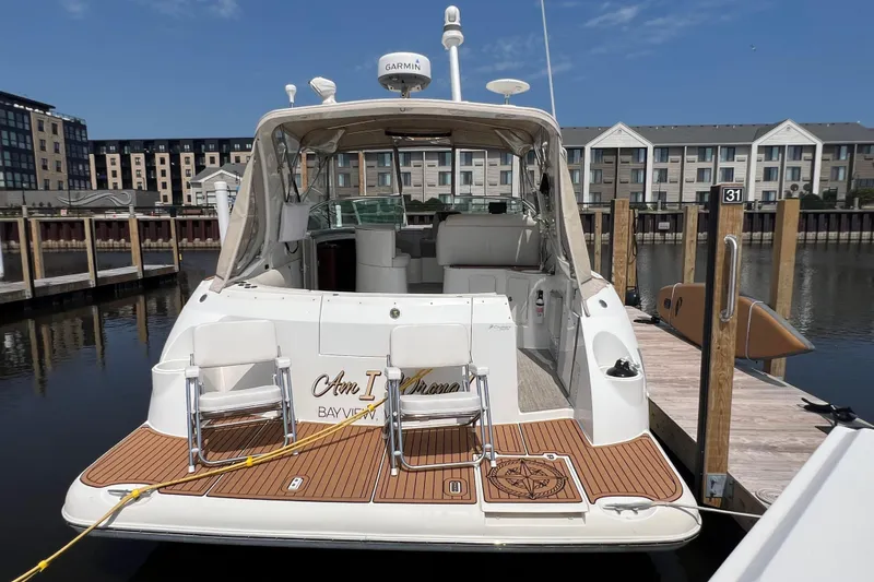 Slide: The Image of 2001 Cruisers Yachts 3672 Express docked at marina, rear view with open cockpit. - 3