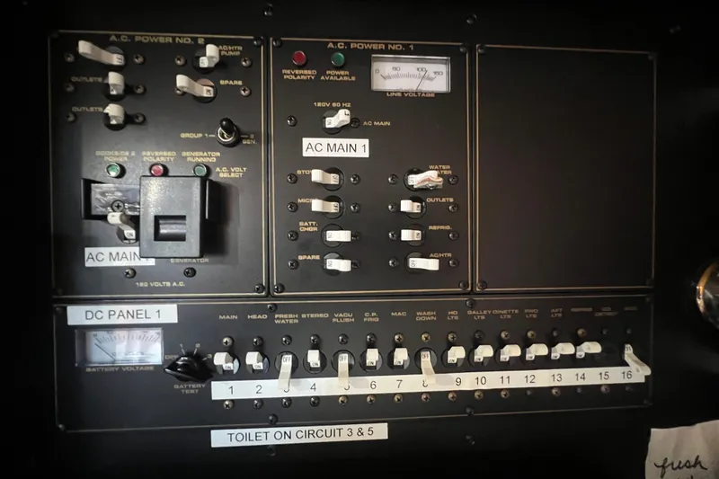 Slide: The Image of Electrical control panel of a 2001 Cruisers Yachts 3672 Express, featuring AC and DC switches. - 31